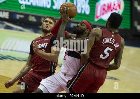 Washington, District of Columbia, USA. 18th Oct, 2018. Washington Wizards guard John Wall (2) shoots while defended by Miami Heat guard Tyler Johnson (8) and forward Derrick Jones Jr. (5) during the game between the Washington Wizards and Miami Heat at Capitol One Area on October 18, 2018 in Washington, DC. Credit: Alex Edelman/ZUMA Wire/Alamy Live News Stock Photo