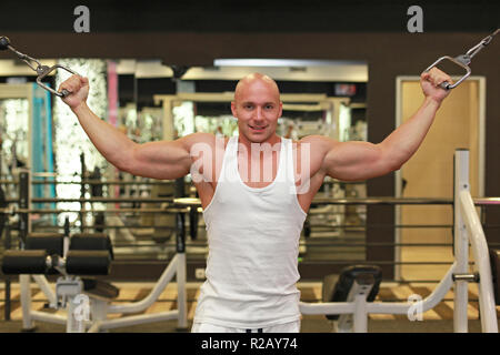 Young strong man workout exercise in gym Stock Photo