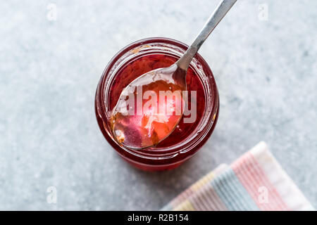 Homemade Jam of Rose Petals in Jar with Spoon / Marmalade. Organic Food. Stock Photo