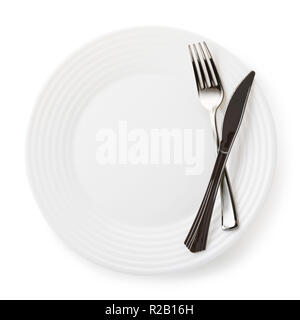Fork and knife on empty white ceramic plate, isolated Stock Photo