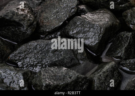 Close up of rough wet granite stones background Stock Photo