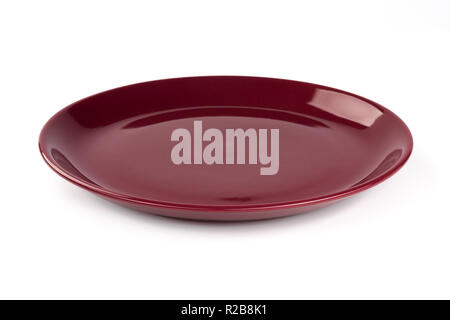 Pastel wine red colored plate isolated on white background, front view, clipping path, excluding the cast shadow, included. Stock Photo