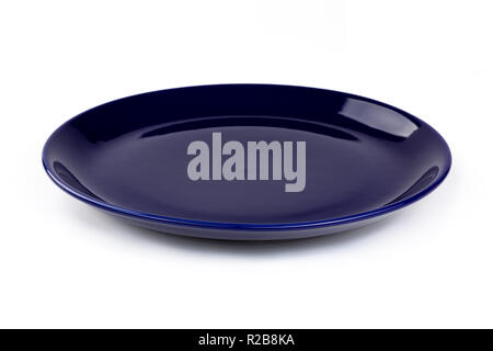Dark blue colored plate isolated on white background, front view, clipping path, excluding the cast shadow, included. Stock Photo