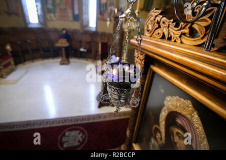 BUCHAREST, ROMANIA - October 27, 2018: Candle near a Virgin Mary icon, in a orthodox christian church, in Bucharest Stock Photo