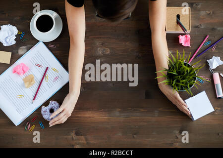 Woman Cleaning Up Office Table Stock Photo