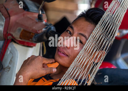 Don Khone, Laos - April 24, 2018: Close up portrait of a lao man resting in a hammock Stock Photo