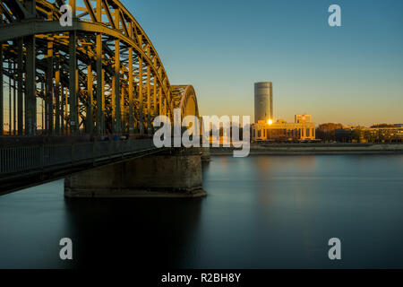 View of the Hohenzollern Bridge, the Hyatt Regency, the Cologne Triangle and the long River Rhine at the Blue Hour in Germany Cologne 2018. Stock Photo