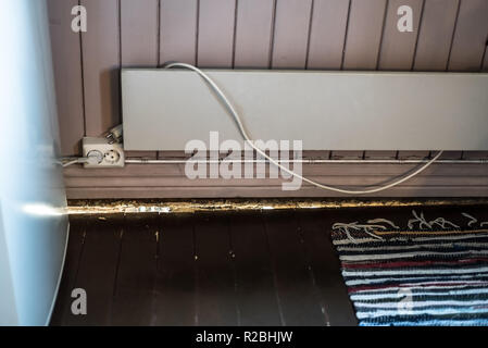 Damaged, unsolid old wooden flooring with a dangerous and unsafe big crack problem in the house construction in a rustic kitchen with retro style Stock Photo