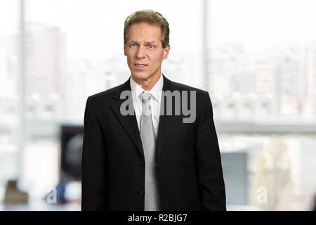 Portrait of startled speechless insulted man. Shocked businessman with frowning brows. Facial expression of dissapointment. Stock Photo