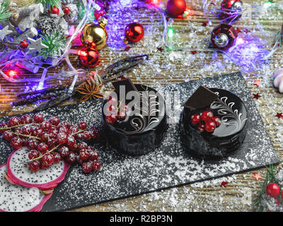 chocolate cake with red currants. dessert on the table close up. New Year christmas composition,decoration. Stock Photo