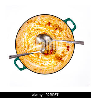 Pan of leftover Paella with spoons on a white background Stock Photo
