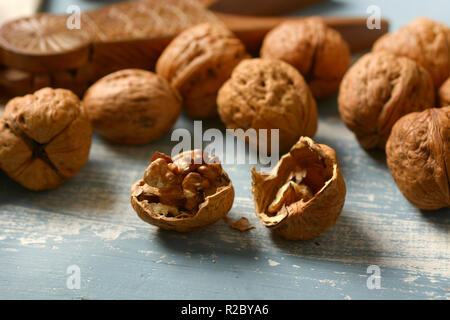 italian walnuts on the colored wooden table - closeup Stock Photo