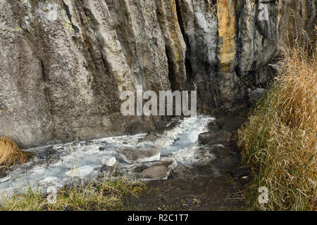 A natural sulpher spring bubbling out from under the mountain rock in Jasper National Park in Alberta Canada. Stock Photo