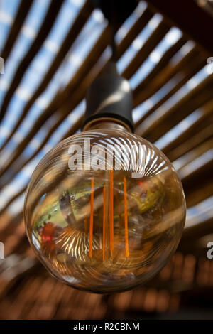 Reflections on the surface of an energy saving LED light bulb create beautiful patterns. Stock Photo