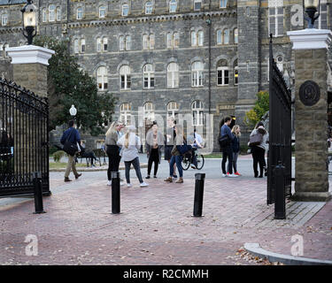 Georgetown University entrance gate with college students talking laughing Stock Photo