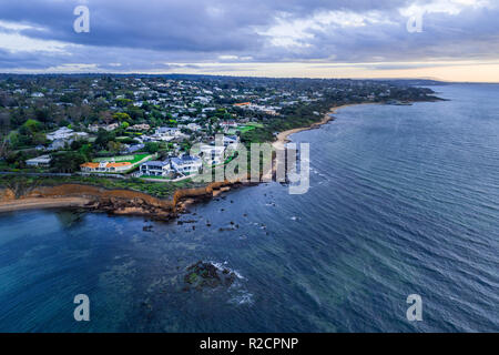 Aerial view of luxury houses on Mornington Peninsula coastline at sunset Stock Photo