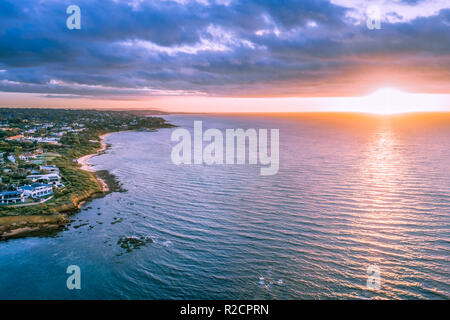 Sunset over ocean near coastline aerial view Stock Photo