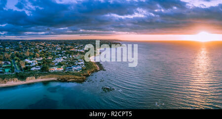 Sunset over ocean near coastline aerial panoramic landscape Stock Photo