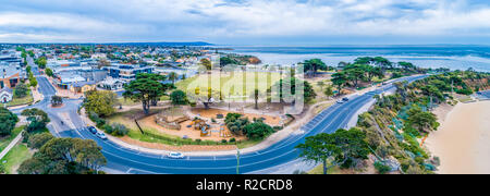 Aerial panorama of playground and park near Mornington Pier with surrounding residential area in Melbourne, Australia Stock Photo