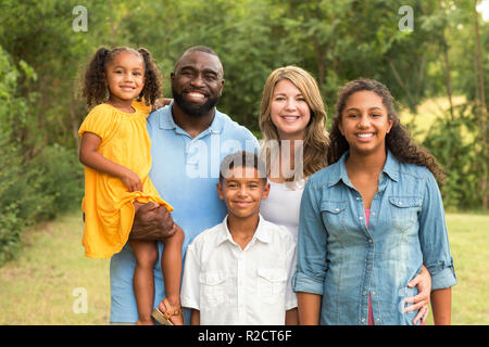 Portrait of a multi ethnic family laughing. Stock Photo