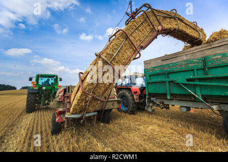 Tractors working on a farm field, - agricultural machines at work Stock Photo