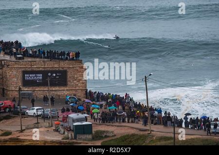 Nazare, Portugal. 18th Nov, 2018. Surfers tow in to giant waves at Portugal’s premier big wave spot Nazarè as a huge swells hit European coast line over the weekend Credit: Andy Bush/Alamy Live News Stock Photo