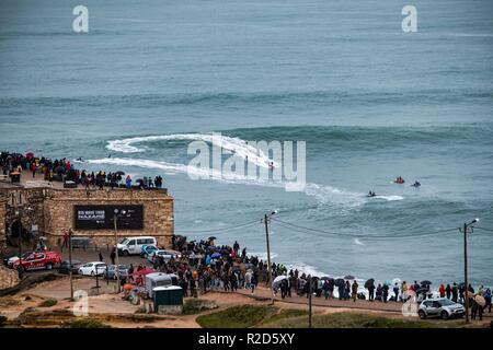 Nazare, Portugal. 18th Nov, 2018. Surfers tow in to giant waves at Portugal’s premier big wave spot Nazarè as a huge swells hit European coast line over the weekend Credit: Andy Bush/Alamy Live News Stock Photo