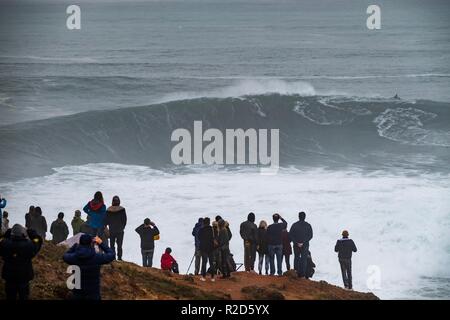 Nazare, Portugal. 18th Nov, 2018. Surfers tow in to giant waves at Portugal’s premier big wave spot Nazarè as a huge swells hit European coast line over the weekend Credit: Andy Bush/Alamy Live News Stock Photo