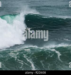 Nazare, Portugal. 18th Nov, 2018. Surfers tow in to giant waves at Portugal’s premier big wave spot Nazarè as a huge swells hit European coast line over the weekend Credit: Andy Bush/Alamy Live News Stock Photo