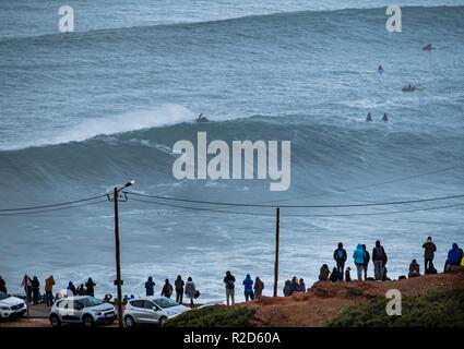 Nazare, Portugal. 18th Nov, 2018. Surfers tow in to giant waves at Portugal’s premier big wave spot Nazarè as a huge swells hit European coast line over the weekend Credit: Andy Bush/Alamy Live News Stock Photo