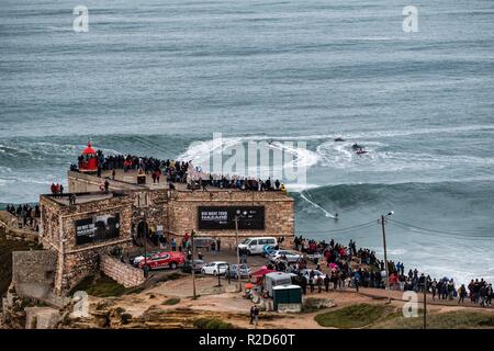 Nazare, Portugal. 18th Nov, 2018. Surfers tow in to giant waves at Portugal’s premier big wave spot Nazarè as a huge swells hit European coast line over the weekend Credit: Andy Bush/Alamy Live News Stock Photo