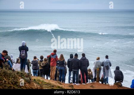 Nazare, Portugal. 18th Nov, 2018. Surfers tow in to giant waves at Portugal’s premier big wave spot Nazarè as a huge swells hit European coast line over the weekend Credit: Andy Bush/Alamy Live News Stock Photo