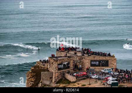 Nazare, Portugal. 18th Nov, 2018. Surfers tow in to giant waves at Portugal’s premier big wave spot Nazarè as a huge swells hit European coast line over the weekend Credit: Andy Bush/Alamy Live News Stock Photo