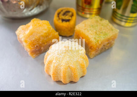 Special turkish dessert assortment with tea set. Kanafeh, baklava, Ma'amoul and Makroudh pastries Stock Photo