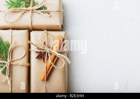 Christmas composition. Christmas gift, pine cones, fir branches on stone white background. Flat lay, top view, copy space. Stock Photo