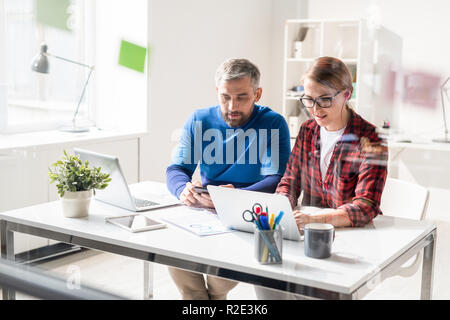 Busy app developers using modern devices Stock Photo