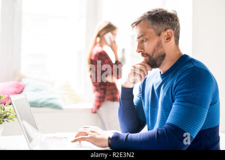 Focused manager analyzing online information Stock Photo