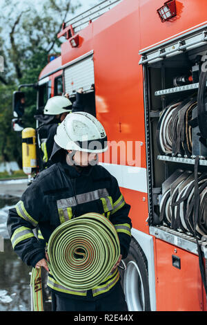A firefighting team putting water on a fire in an industrial building ...