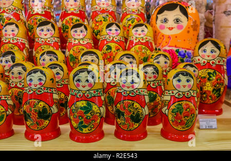 Sankt-Peterburg, Russia - October 05, 2015: Display of colorful traditional Russian matryoshka nesting dolls on a shelf with a price tag, in a souveni Stock Photo