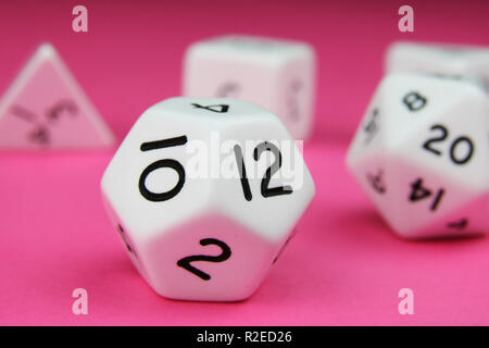 Set of white complete regular platonic solid dice on a pink background Stock Photo