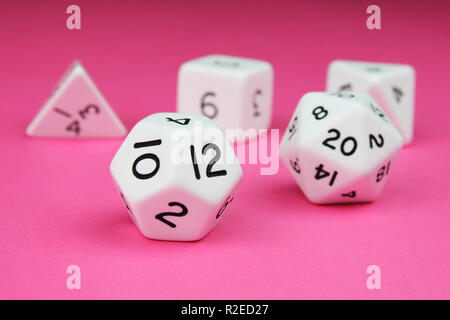 Set of white complete regular platonic solid dice on a pink background Stock Photo