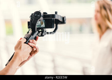 motorized gimbal, videographer using dslr camera anti shake tool  for  stabilizer record video scene. Stock Photo