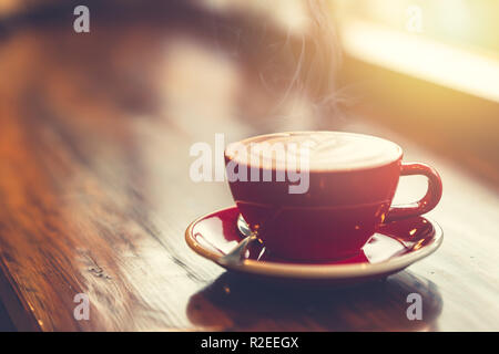 aroma morning coffee on wooden table smoke at windows vintage tone. Stock Photo