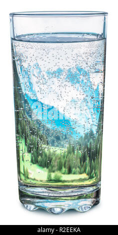 Glass of water with snow mountains tops and green forests inside, as a symbol of freshness and purity. Clipping Path. Stock Photo