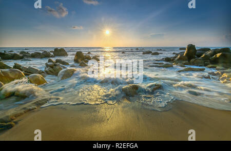 Sunrise ancient fossil reef as radiating star rounded up right edge large rock like shining pearl release, Stock Photo