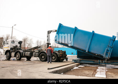 Waste loading operation, loader dumping trash in a truck on a site for ...