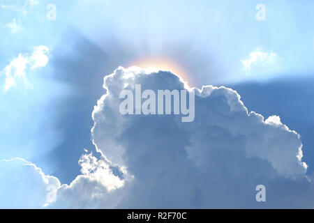 Grey clouds with the dazzling sun shining from the back Stock Photo