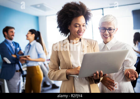 Programmers cooperating at IT company developing apps Stock Photo