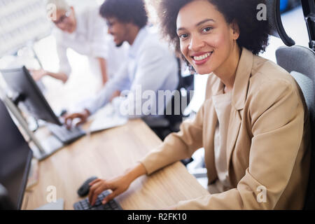 Programmers cooperating at IT company developing apps Stock Photo