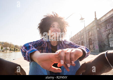 human eyes point of view for nice cheerful black afro young woman enjoying the couple and the man companion together having fun and smile for the outdoor urban city leisure activity. first date concept Stock Photo